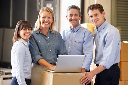 Four small business owners in a distribution warehouse